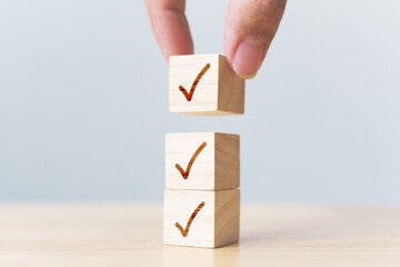 Checklist concept, Check mark on wooden blocks on table with copy space