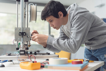 Young student using a 3D printer
