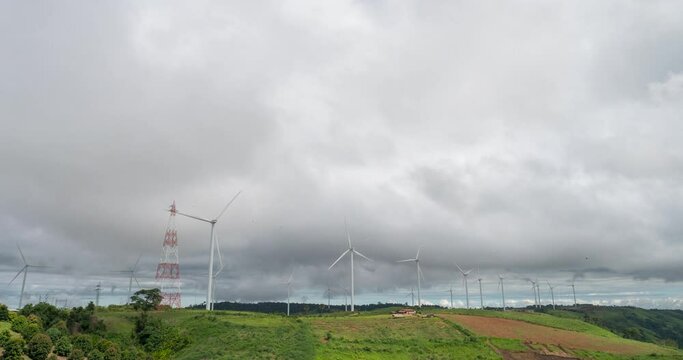 4K Time Lapse  blue sky white cloud bright clear  Wind turbines green mountain nature on sunny day. Beautiful landscape timelapse vibrant nature sunlight. Timelapse motion fluffy white cloud blue sky