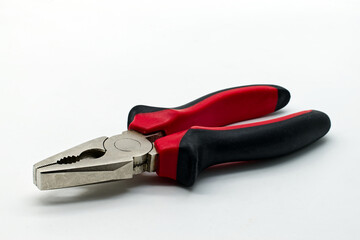 Obraz premium Metal hand pliers with red and black rubber handless isolated on white background