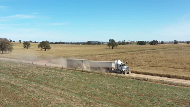 2020 - A twelve wheeler tows a vehicle behind it in the countryside of Parkes, New South Wales, Australia.