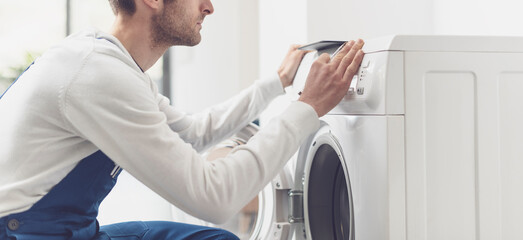 Repairman fixing a washing machine