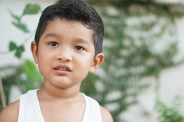 Portrait of cute toddler Asian child little Thai boy 3 year old smile make a happy face concept.  