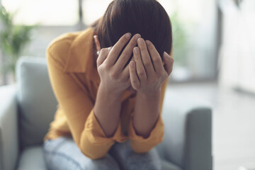 Young lonely woman crying at home