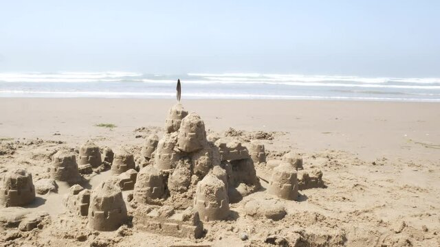 A sandcastle and a Ocean in the background