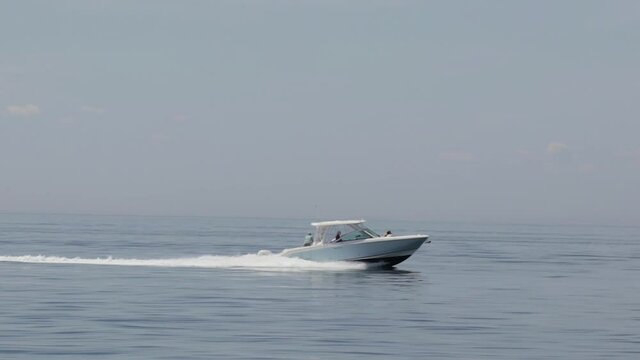 A speed boat on the open ocean in slow motion.