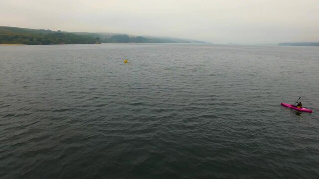 Footage captured on Tomales Bay in sunny and cloudy weather. Subjects are two kayakers. Shot with a camera gimbal on a drone.
