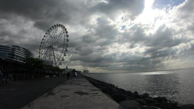 A time-lapse of a Ferris Wheel, the Sky and the Sea