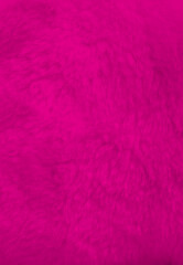 Pink fur background close up view.