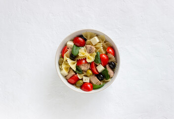 Pasta salad with tuna, tomatoes and white cheese. Farfalle. Healthy eating. Diet.