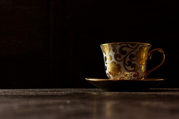 antique tea cup isolated on dark backgrounds