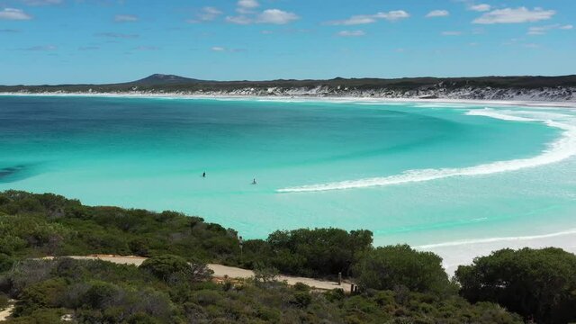 2020 - Excellent aerial shot of surfers wading into the waters of Wharton Bay, Esperance, Australia.