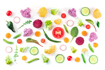 Many fresh vegetable slices, overhead flat lay shot on a white background