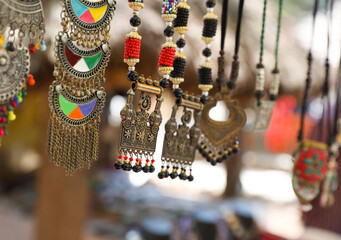 Gold coated Necklaces are hanging in street shop for sale