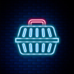 Glowing neon line Pet carry case icon isolated on brick wall background. Carrier for animals, dog and cat. Container for animals. Animal transport box. Colorful outline concept. Vector