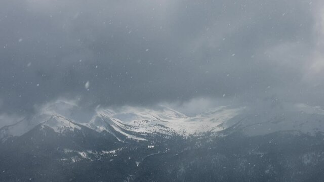 Snowy Forest on top of the mountains in winter during stormy day. Beautiful White Canadian Nature. Taken in Whistler, British Columbia, Canada. Aerial View Slow Motion