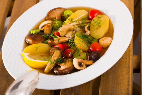 Mushroom broth prepared with boiled honey fungus, lemon and vegetables
