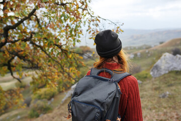 woman tourist with backpack on nature landscape travel adventure