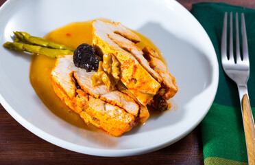 Appetizing slices of spicy roasted turkey breast in mango dipping sauce garnished with marinated asparagus, prune and walnuts..