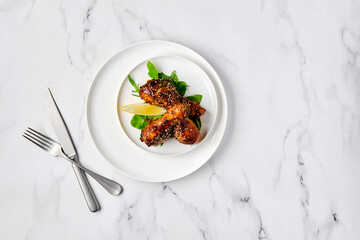 Overhead view of baked chicken legs on a plate