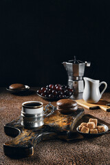 Vintage cup with espresso coffee, chocolate cake and grapes