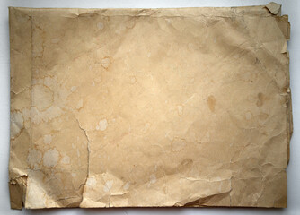 Old yellowed paper with cracks and creases on the white isolate