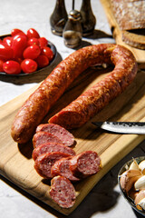 Closeup view of smoked beef sausage rings on wooden cutting board