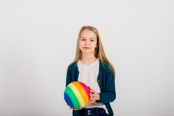 Beautiful girl holding coloured bright ball isolated on white