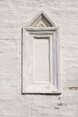 Rectangular blind window in ancient white brick wall. Medieval historical background.