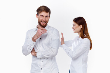 offended woman looks at from a returning man on a light background communication family misunderstanding