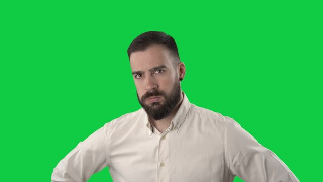 Annoyed displeased business man shaking head and rolling eyes looking at camera. Portrait on green screen background.