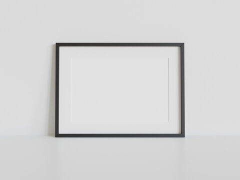 Black frame leaning on white floor in interior mockup. Template of a picture framed on a wall 3D rendering