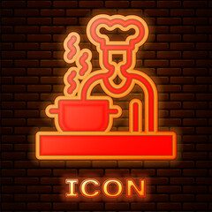 Glowing neon Spanish cook icon isolated on brick wall background. Vector