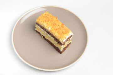 A piece of a layered cake with sour cream. Traditional recipe of Smetannik, sweet cream cake.
