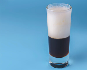 Shot cocktail collection: B52 alcohol cocktail isolated on blue background. Layered cocktail.