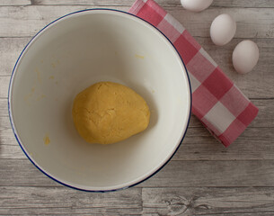 dough for baking a cake base  in a enamel bowl