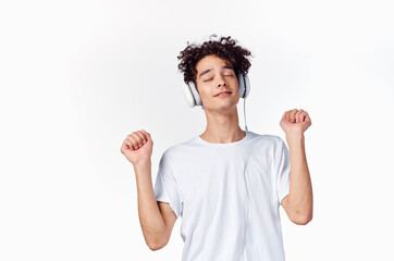 Cheerful Guy in headphones listens to music gesturing with his hands emotions