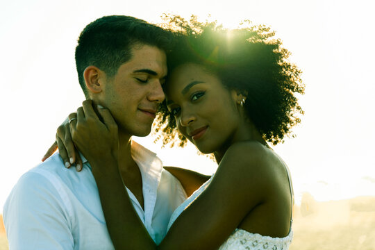 Young romantic couple having embracing fun time in the beach.