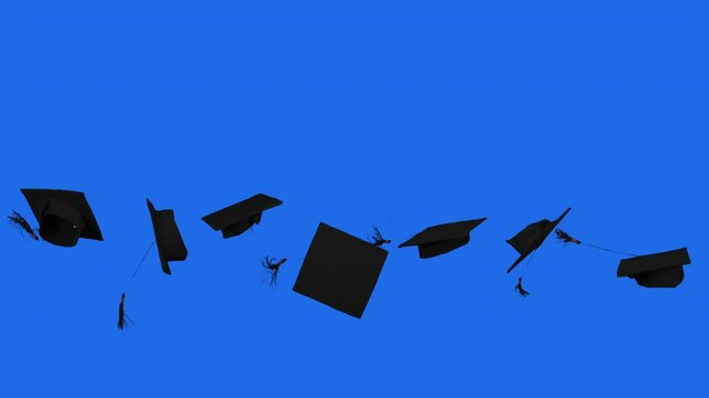 Slow motion of graduation caps thrown on the air in the studio with blue screen background