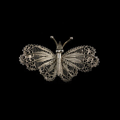 vintage silver brooch in the shape of a butterfly. antique butterfly brooch in flowers - obrazy, fototapety, plakaty