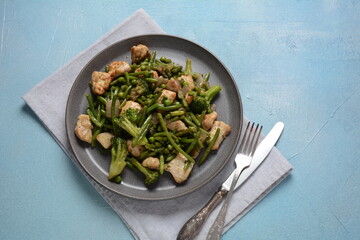 Baked vegetables, broccoli, beans, peas and fried pieces of chicken breast. Healthy food concept.