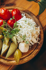 dish of pickled vegetables laid out on a wooden board