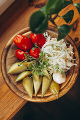 dish of pickled vegetables laid out on a wooden board