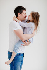 little daughter cuddling and having fun with dad. Happy family. 