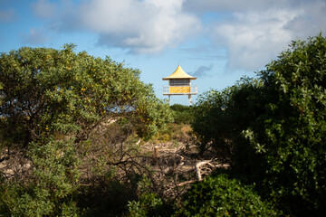 life guard tower view though sand dunes