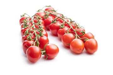 Fresh red cherry tomatoes. Small tomatoes on branch.