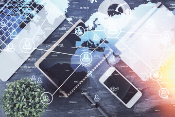 Double exposure of social network theme drawing over table with phone. Top view. People connecting concept.