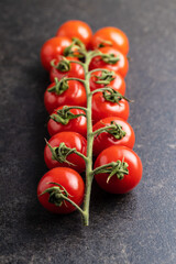 Fresh red cherry tomatoes. Small tomatoes on branch.