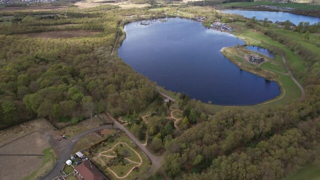 Low level aerial footage over Drumpellier Country Park and Lochend Loch near Coatbridge in Central Scotland.