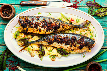 Baked whole scomber with potatoes